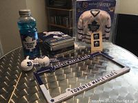 Toronto Maple Leafs collectibles including framed mini jersey, license plate frame, golf balls, Gatorade bottle, Upper Deck collectible tin.