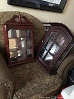 Two cherry wood display cases side by side showing the size difference and design details.