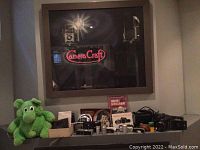 Overall view of lot on shelf beneath framed art