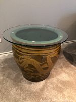 Front view of the ceramic urn with glass top showing dragon design.