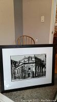 Front view of one framed black-and-white print depicting a historic Toronto building facade