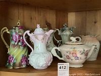 All six pieces displayed on a wooden shelf