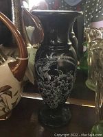 Black marble vase with dragon and flower etching, approx 7 inches tall