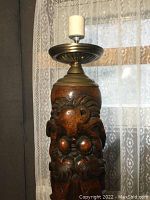Close-up view of the lamp's midsection showing detailed wood carving of a Chinese dragon.