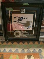 Framed action shot of Evgeni Malkin in Pittsburgh Penguins uniform, signed, black wooden frame with engraved nameplate.
