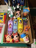 Photo of the lot showing Disney bubble bath bottles including Mickey Mouse, Minnie, Donald, Goofy, Daisy, and Pluto, along with other figurines and bobblehead.