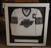 Full view of framed white and silver Los Angeles Kings jersey with Wayne Gretzky signature