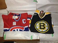 Folded red Montreal Canadiens #9 and black Boston Bruins #4 jerseys side by side