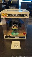 Photo of sealed Funko Pop Heroes Moment Batman and Catwoman #291 collectible in original box from front angle.