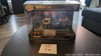 Front view of unopened Funko Pop Batman and Robin Comic Moments set with plastic protector on table.