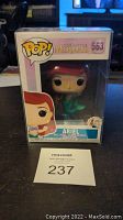 Front view of unopened Funko Pop box showing Ariel figure, number 563, with seller lot number card in front.
