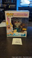 Front view of unopened King Triton Funko Pop in box with Pop Protector and Hot Topic exclusive sticker