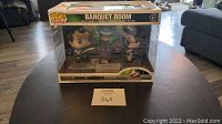 Front view of unopened Funko Pop Movies Ghostbusters Banquet Room Movie Moments box on table.