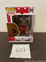Front view of unopened Funko Pop box with Michael Jordan figure visible inside, showing the Pop Basketball branding, Chicago Bulls logo, and number 84.