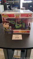 Front view of boxed Funko Pop Rides Toy Story Woody with RC in clear pop protector.