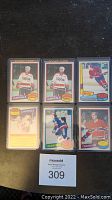 Top view of six NHL hockey cards from 1980-1981 lot, showing two Mike Gartner rookie cards with Capitals uniform, and other player cards including Islanders and Canadiens.