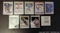 Lot of 8 NHL hockey rookie cards arranged side by side on a flat surface, including Alexander Mogilny, Mats Sundin, Mike Modano, Pavel Bure.