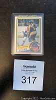 Rookie card front view of Doug Gilmour hockey card in protective sleeve with MaxSold auction lot number.