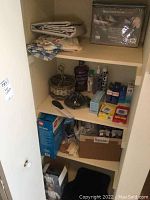 Closet shelves containing king sheet set, vintage linens, healthcare products, band aids, incontinence pads, and personal care items
