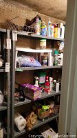Photo of metal shelving unit with various chemical bottles, cleaning supplies, garden products and boxes.