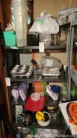 Front view of metal utility shelf containing various household items, showing overall structure and condition