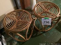 Two bamboo stools side by side showing circular woven seats and rounded bases with bamboo bindings