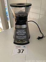 View of the assembled Cuisinart burr grinder with bean hopper and power cord visible.