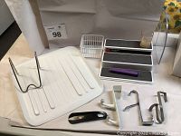 Photo of dish tray drainer, utensil holder, non-skid cabinet organizers, small basket and over-the-door hooks