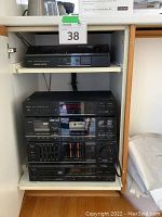 Full stacked Sansui audio components on sliding shelf