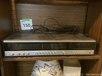 Full front view of the Telefunken Orchestra HiFi 101 tuner in wooden bookshelf case showing control knobs and tuning display.