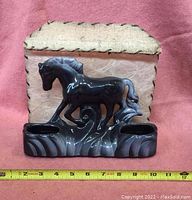 Front view of the ceramic horse figurine base with dual candle holders and part of the original lamp shade.