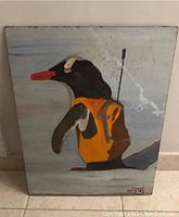 Front view of painted wooden panel showing the penguin in orange vest with spear, signed by Dmytry