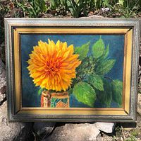Frontal image of framed painting showing bright yellow flower in beer stein vase with green leaves against dark blue background.