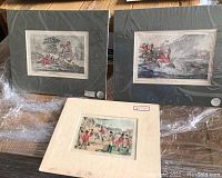 Three horse sport lithographs shown laid out. Two prints framed in dark mats and glass, one print mounted in cream-colored mat with price label.