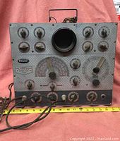 Front view of Philco Model 7008 Visual Alignment Generator showing multiple control dials, circular output area, and measurement scale.