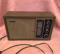 Full frontal view of Sony TFM9440W radio showing wooden cabinet, speaker grille and control panel with knobs.