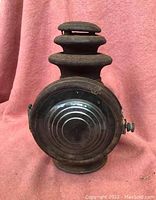 Front view of the Dietz Champion steel carriage lamp showing concentric circle glass lens and vented top design