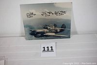 Color 10x8 glossy photo showing three WWII Flying Tigers P-40 fighter planes in flight with clear autographs of three pilots including R.T. Smith, Bob Neale, Duke Hedman
