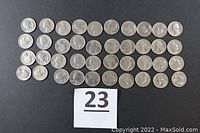 40 U.S. quarters arranged in rows with some visible wear, showing the front side.