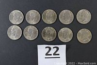 Ten 1976 Eisenhower Bicentennial silver-colored dollar coins arranged in two rows on black background.