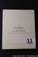 Closed green presentation box cover embossed with White House and printed title