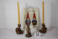 Full set including two gnome candlestick holders with candles, a gnome doctor figurine, and a signed gnome book placed behind them