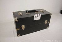 Closed wooden tool box with black covering and steel corner protectors.