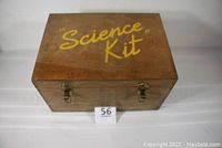 Closed top view of vintage wooden box labeled 'Science Kit' in yellow letters