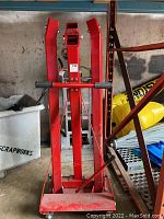 Full front view of folded engine hoist showing uprights, boom and base