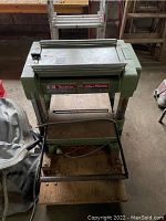 Front view of Makita 400mm planer on wooden dolly showing overall setup and condition.