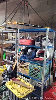 Two metal rolling shelving racks storing various tools and items.