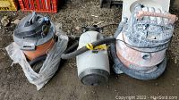 Three vacuums together showing condition and size comparison