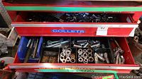 Top view of two drawers containing socket wrenches and assorted sockets including ratchet handles, socket extensions, and adapters.