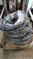 Two large coiled gray fabric ventilation tunnels placed on a metal cart, showing their circular shape and coiling details.
